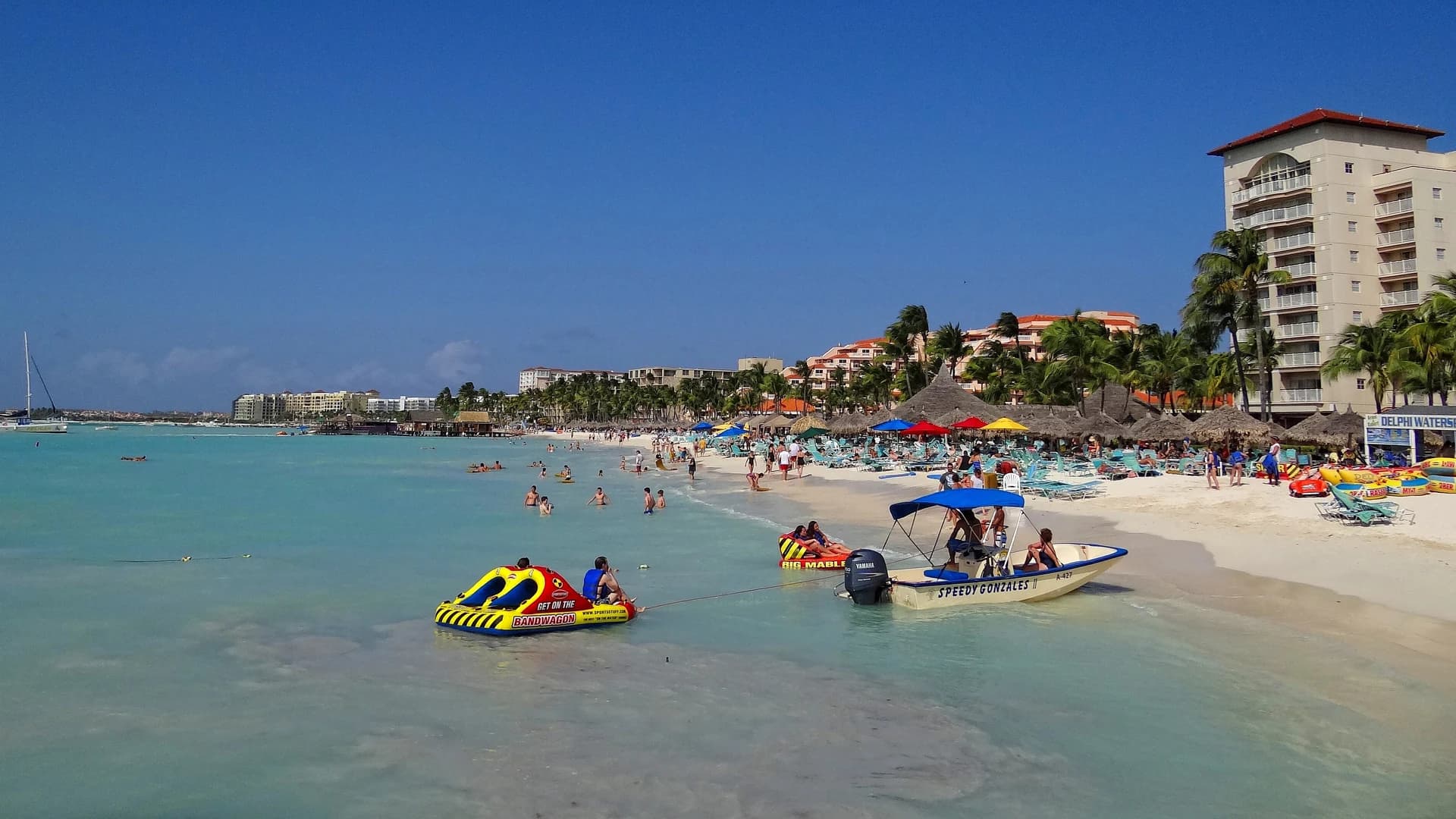 Palm Beach resorts and turquoise water in Aruba, with water sports boats near the shore