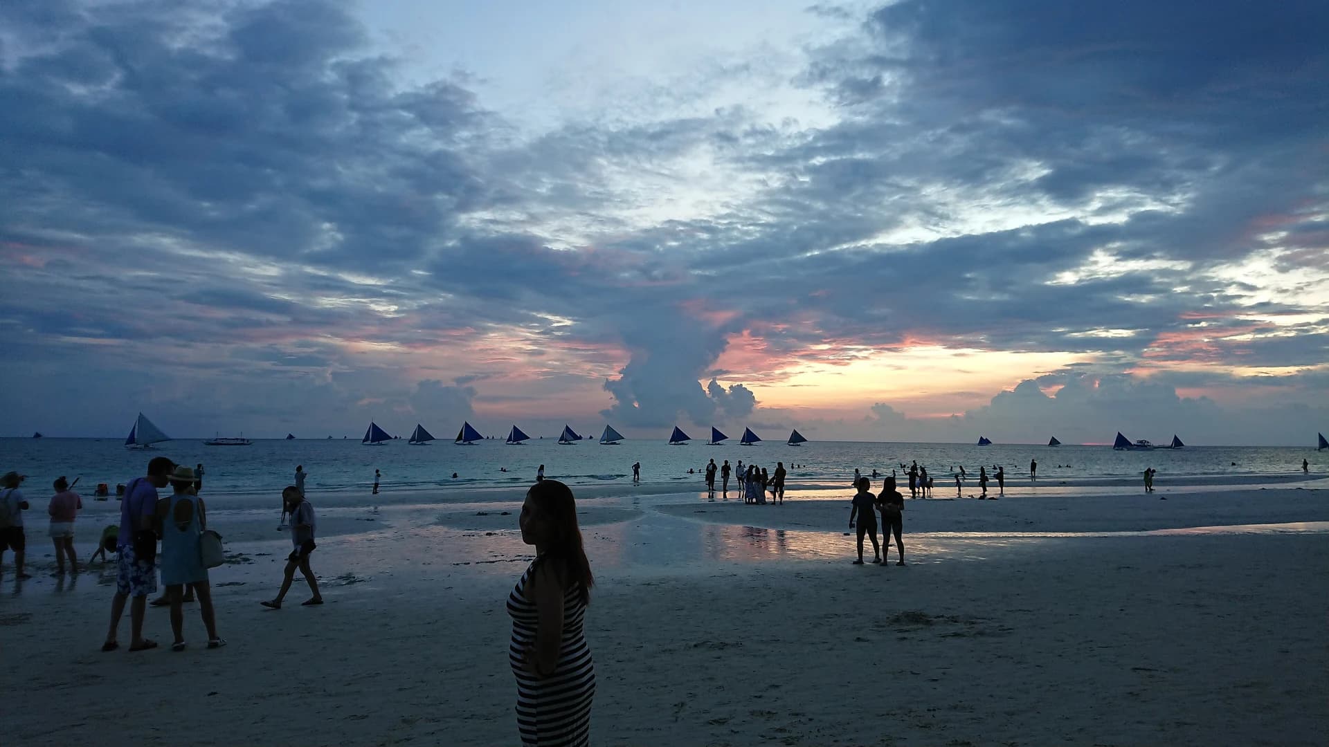 Sunset over sailboats on Station 1 beach, Boracay Island, Philippines