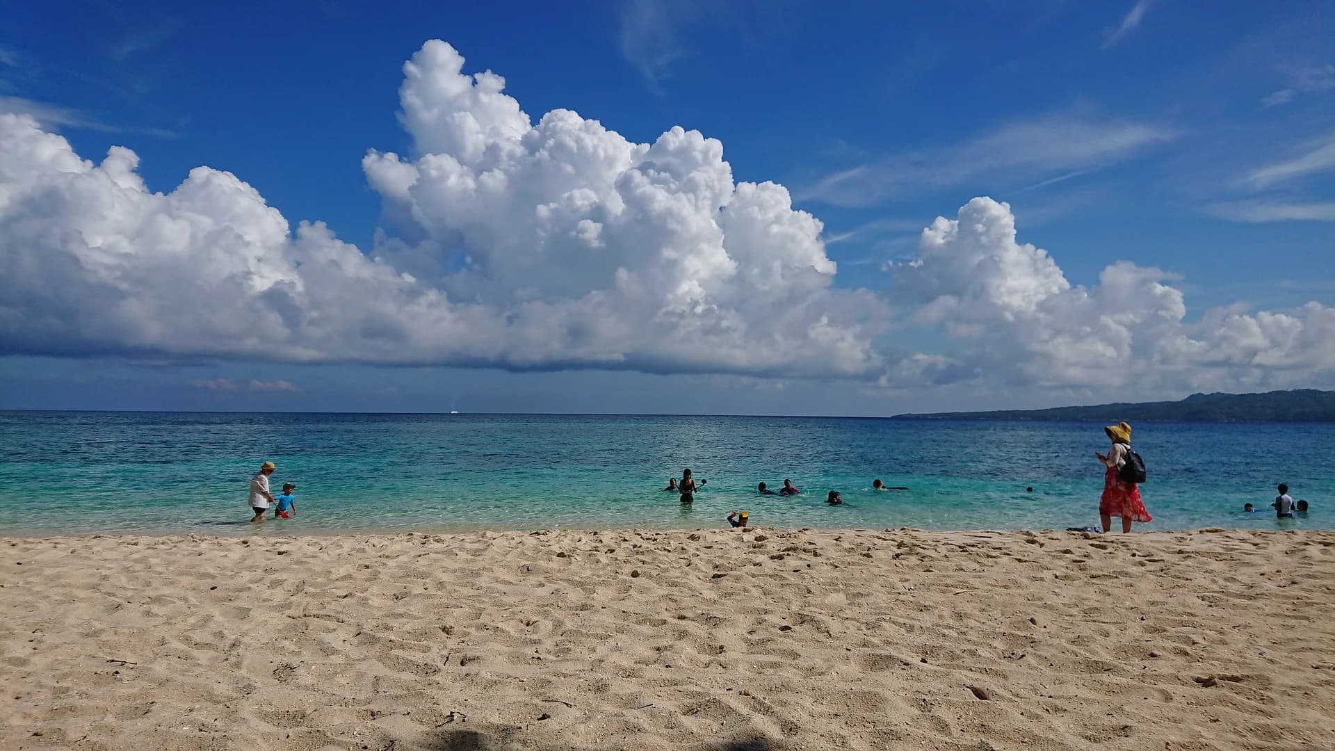 Swimmers in turquoise water off Puka Beach, Boracay, Philippines