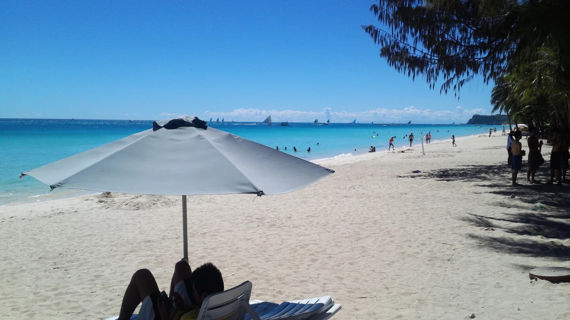 White Beach, Boracay, with traditional paraw sailboats on the turquoise water