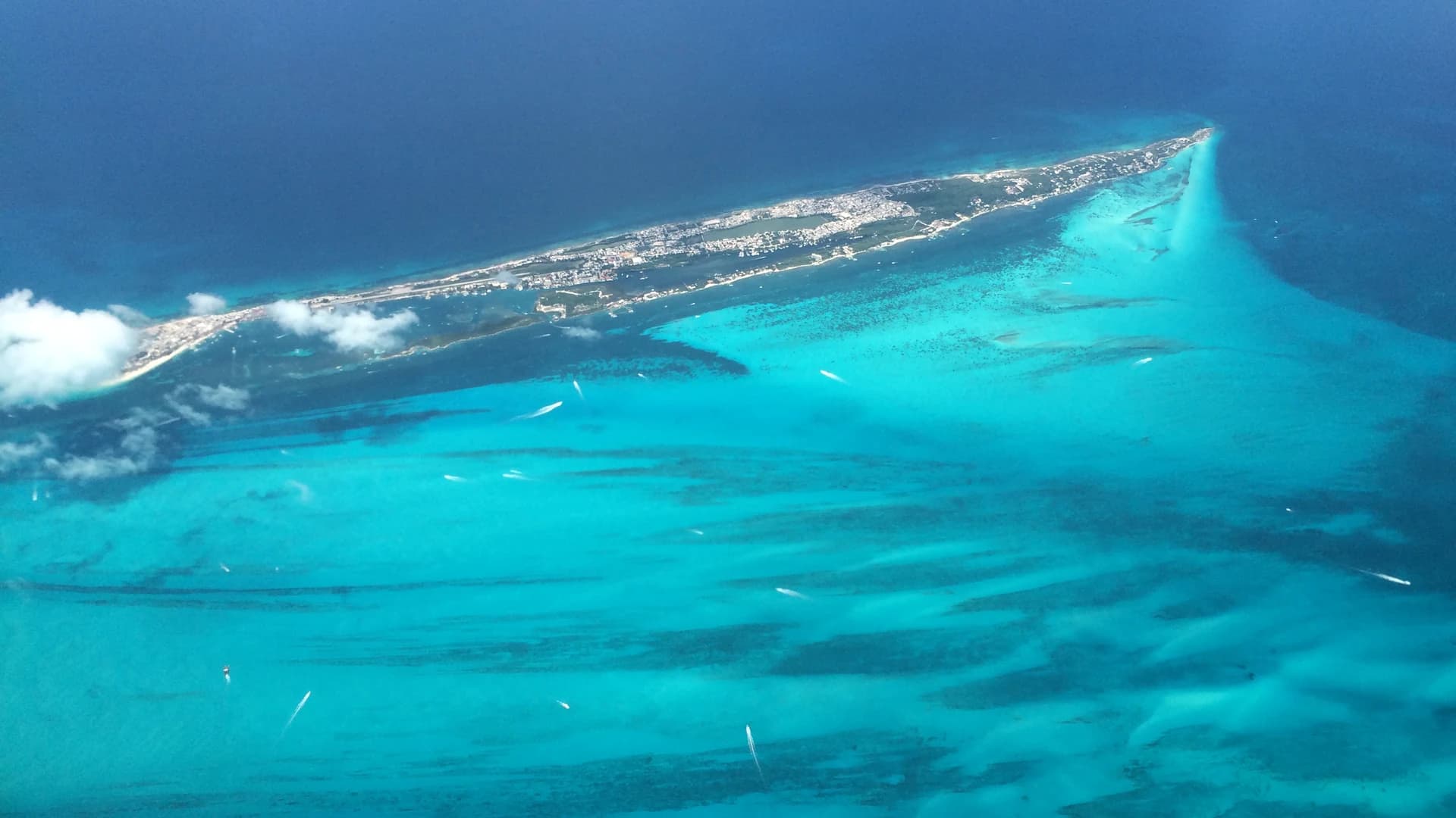 Aerial view of Isla Mujeres and the turquoise reef shallows off Cancún, Mexico