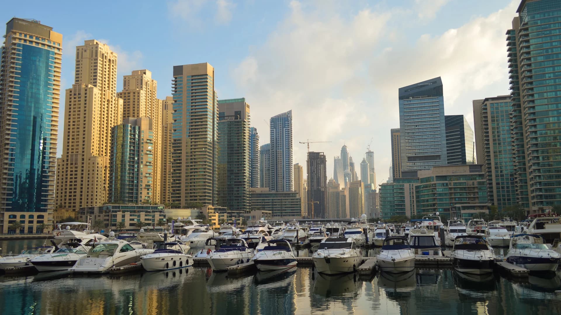 Yachts moored in Dubai Marina with the skyline behind