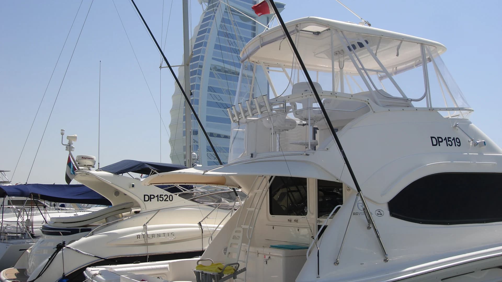 Private yachts moored in Dubai Marina with the Burj Al Arab behind