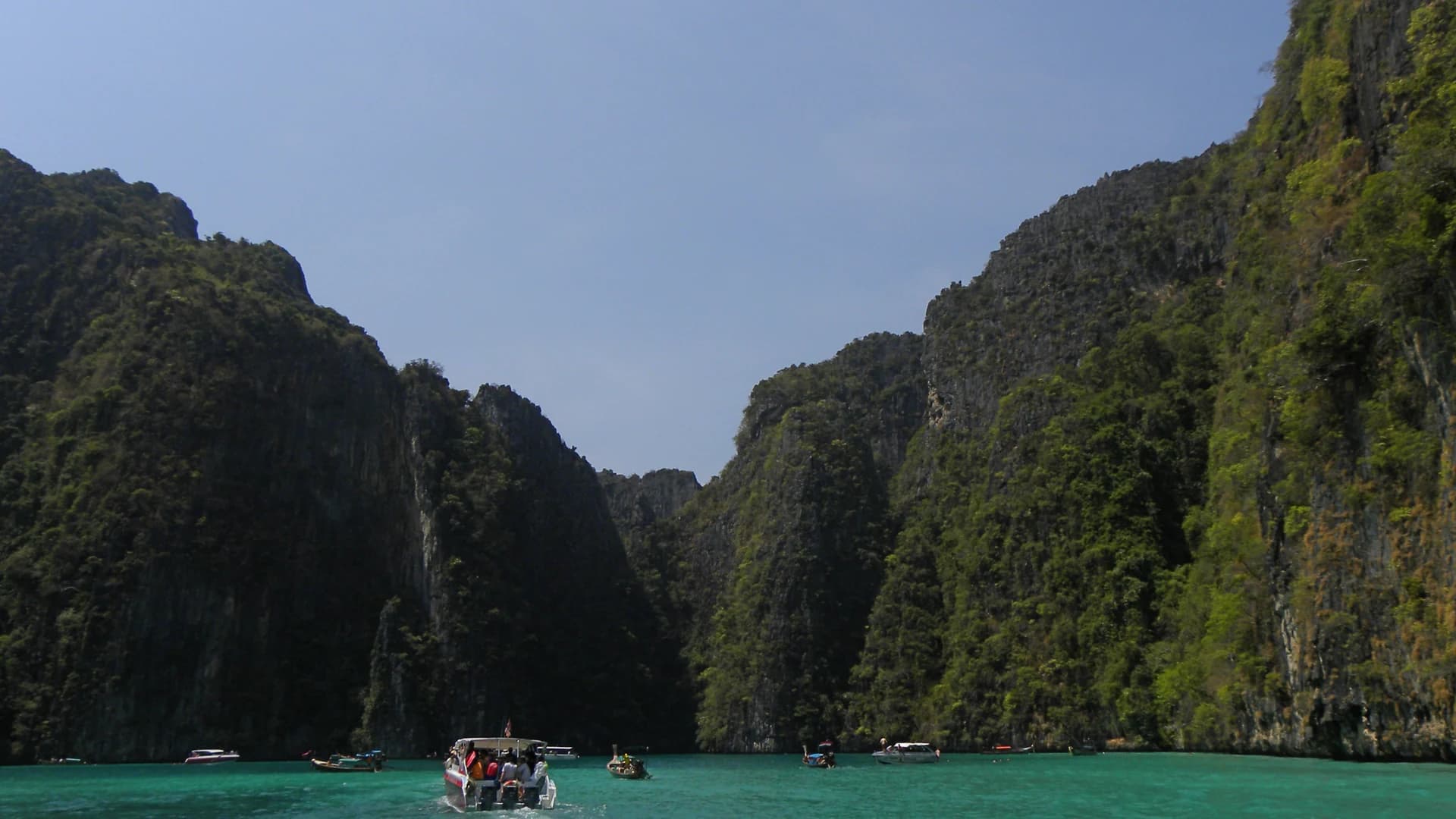 Boats crossing the turquoise water of Pileh Lagoon, Ko Phi Phi Leh, Thailand