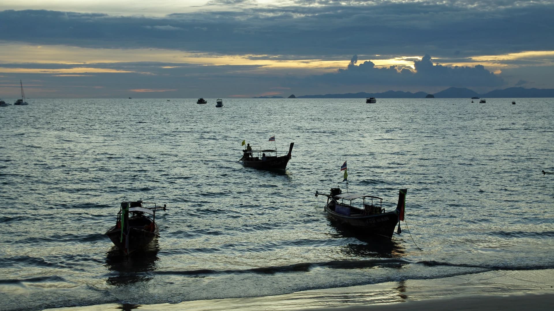 Longtail boats off Ao Nang beach at dusk, Krabi, Thailand