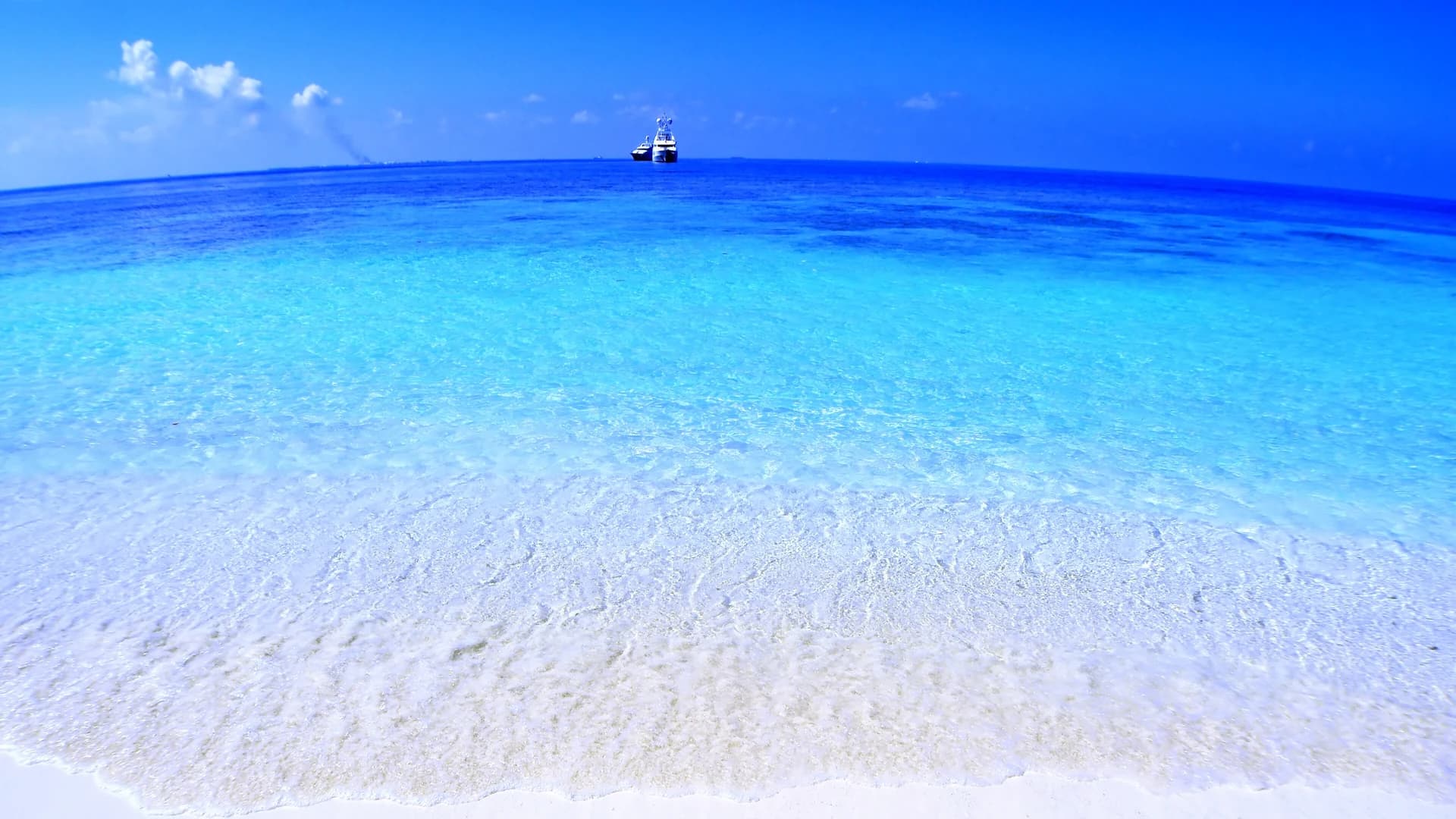 Empty white-sand beach and turquoise lagoon in the Maldives