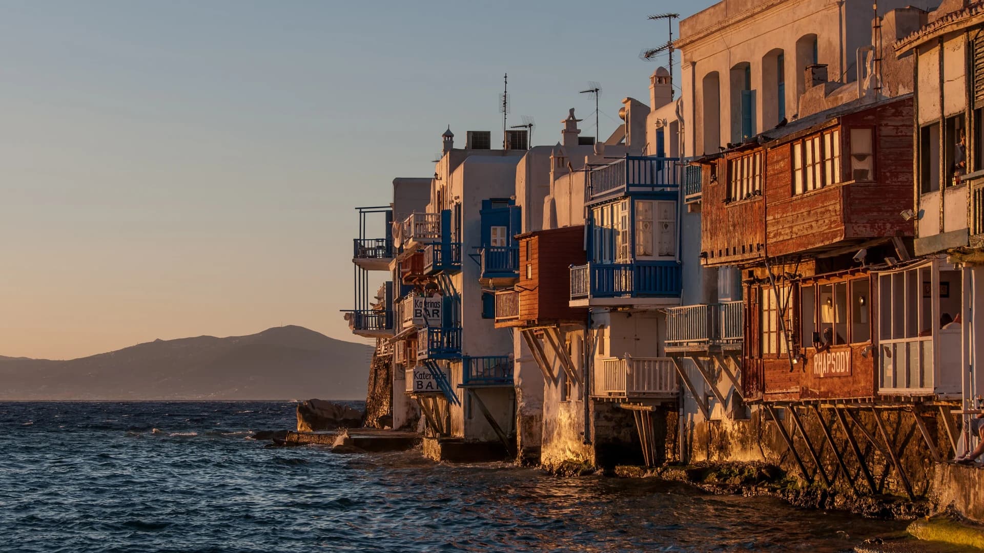 Sunset over Mykonos island, Cyclades, Greece – whitewashed buildings and the Aegean Sea
