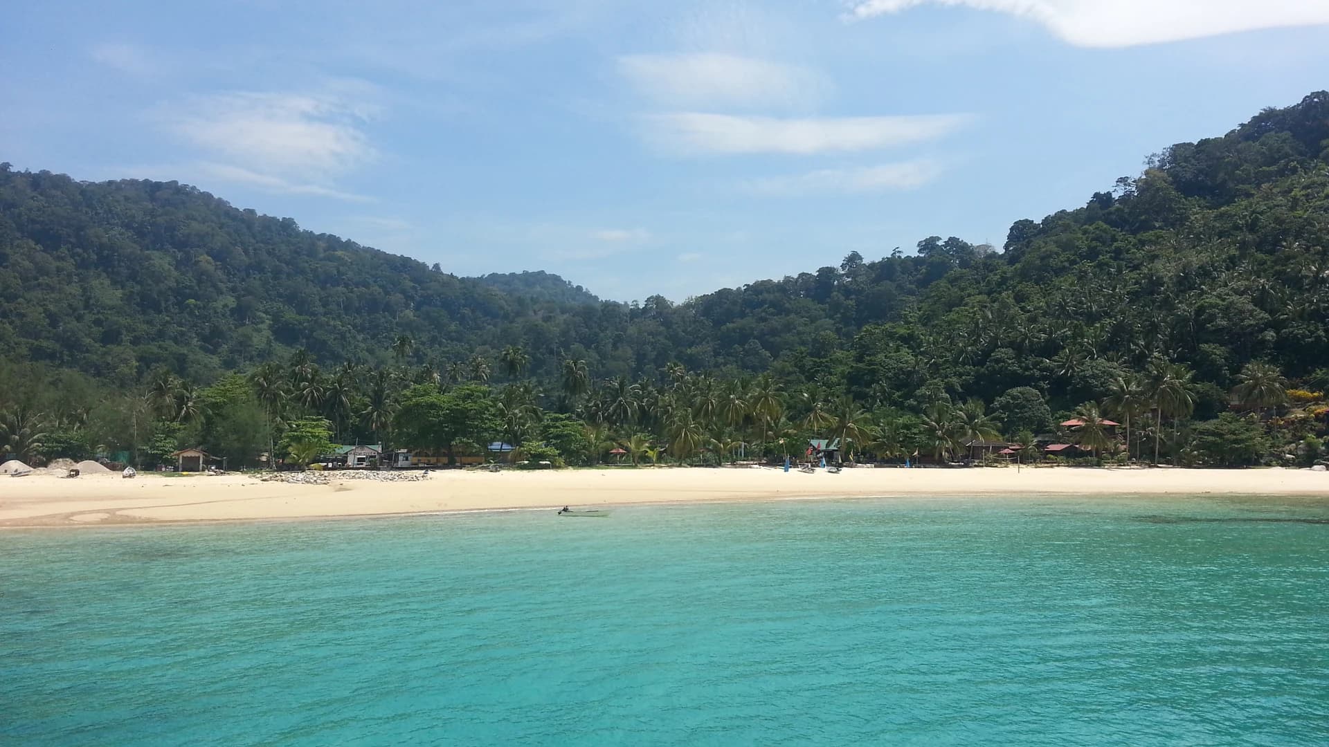 Salang Beach on Tioman Island, Malaysia, with jungle-covered hills behind