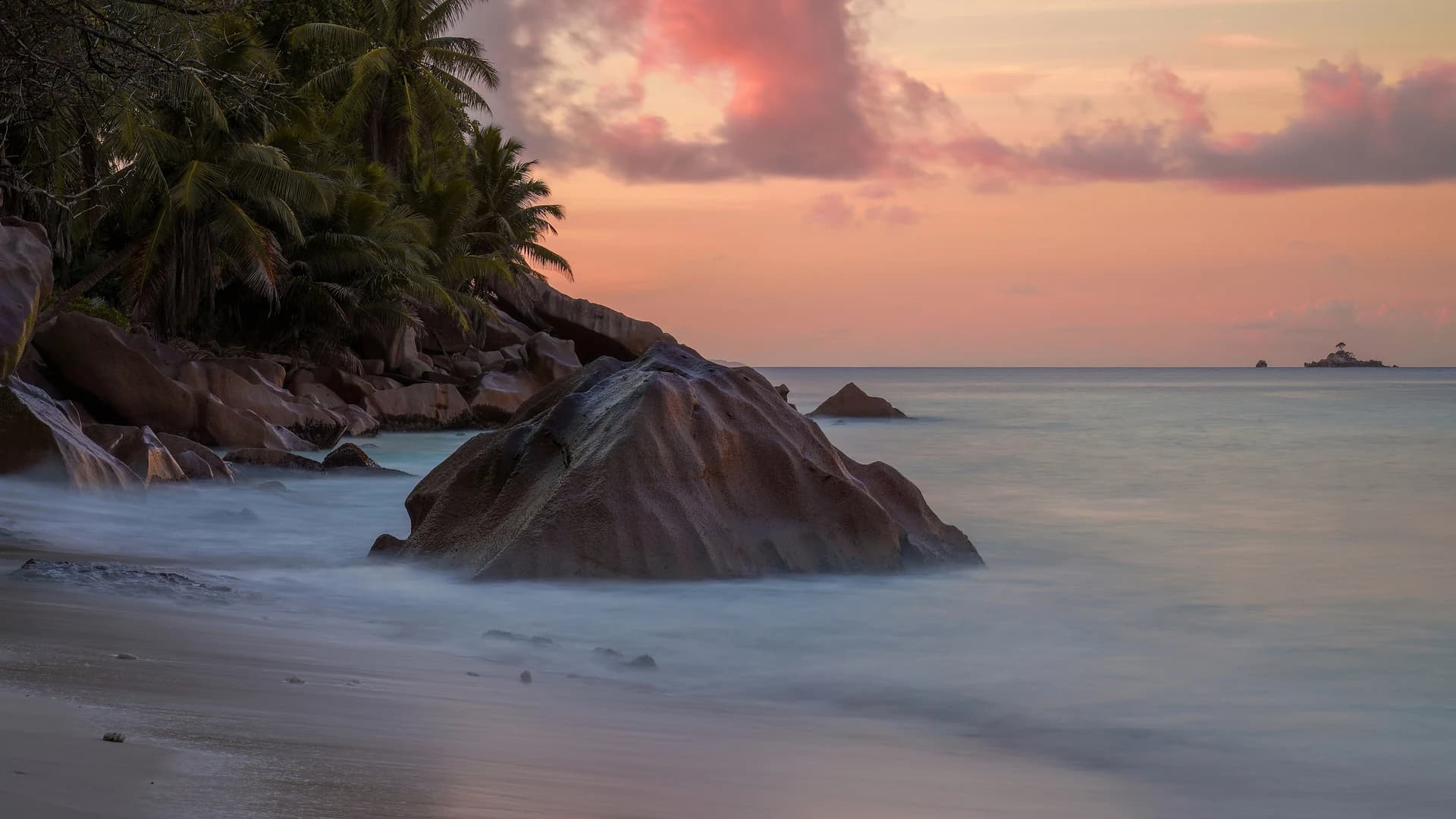 Granite boulders and turquoise water on a beach in the Seychelles
