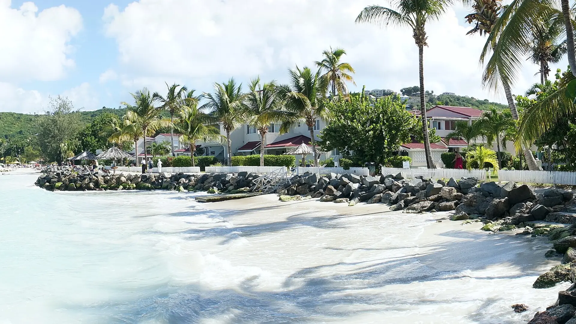 Dickenson Bay beach in Antigua, turquoise water, white sand and palm trees