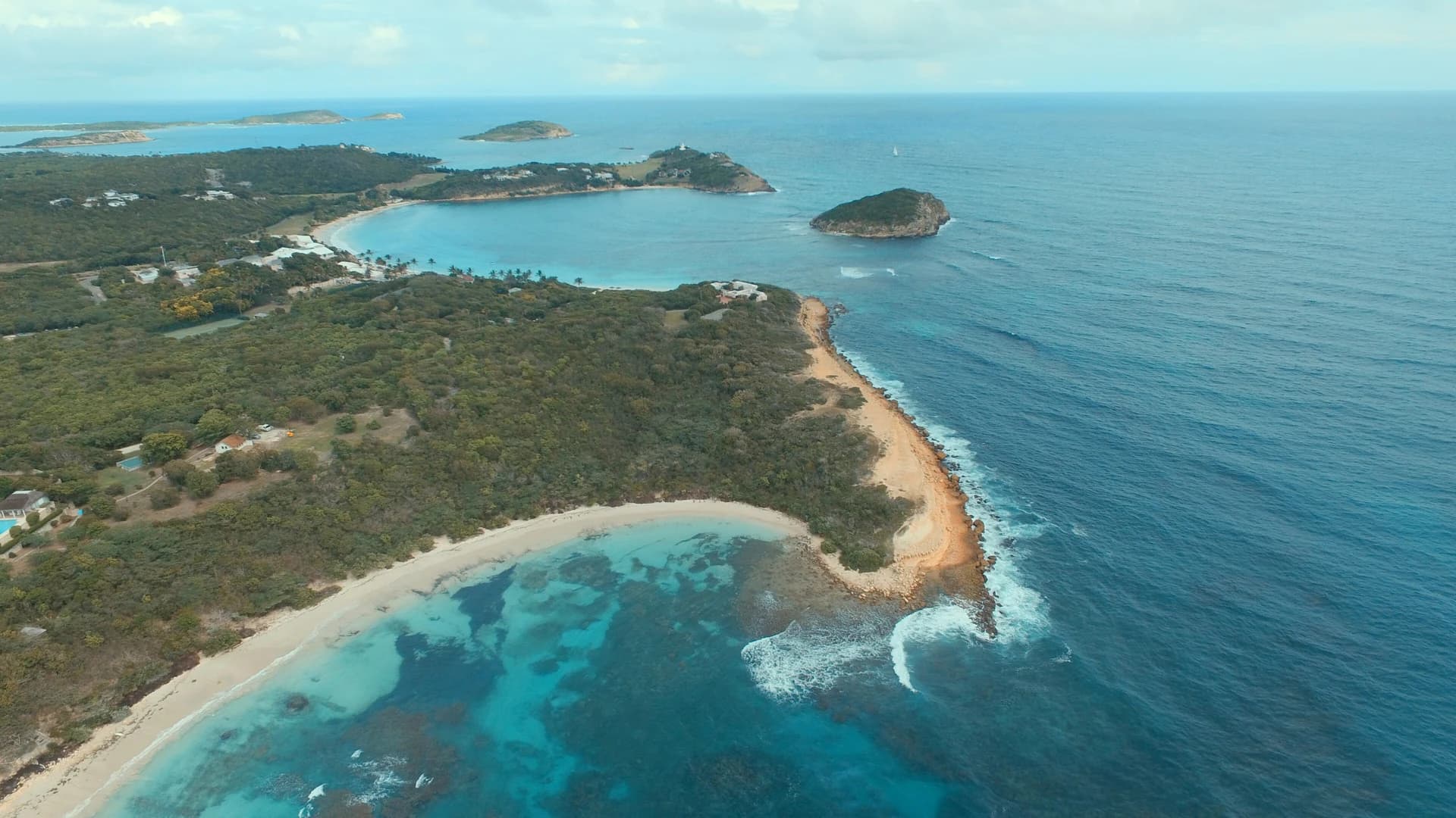 Aerial view of Half Moon Bay's turquoise coastline, Antigua