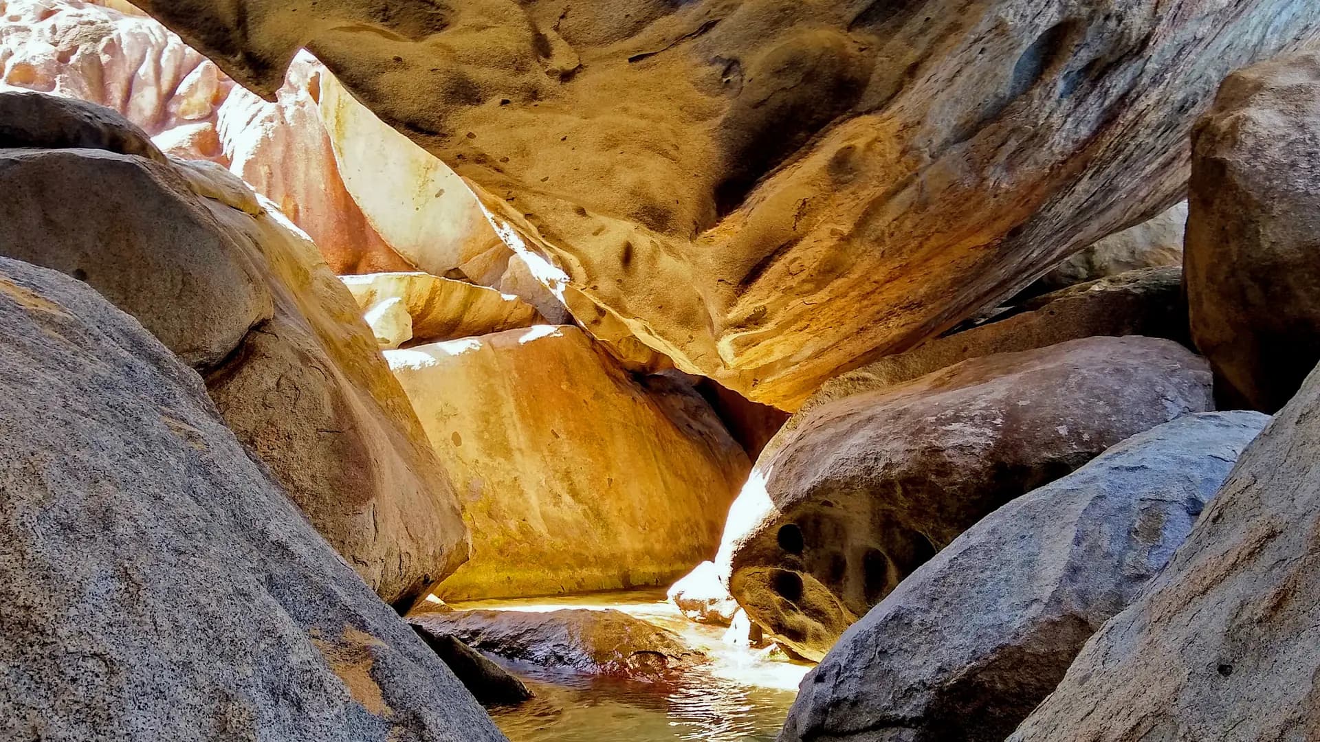 Sunlight filtering through the granite boulder grottoes of The Baths, Virgin Gorda