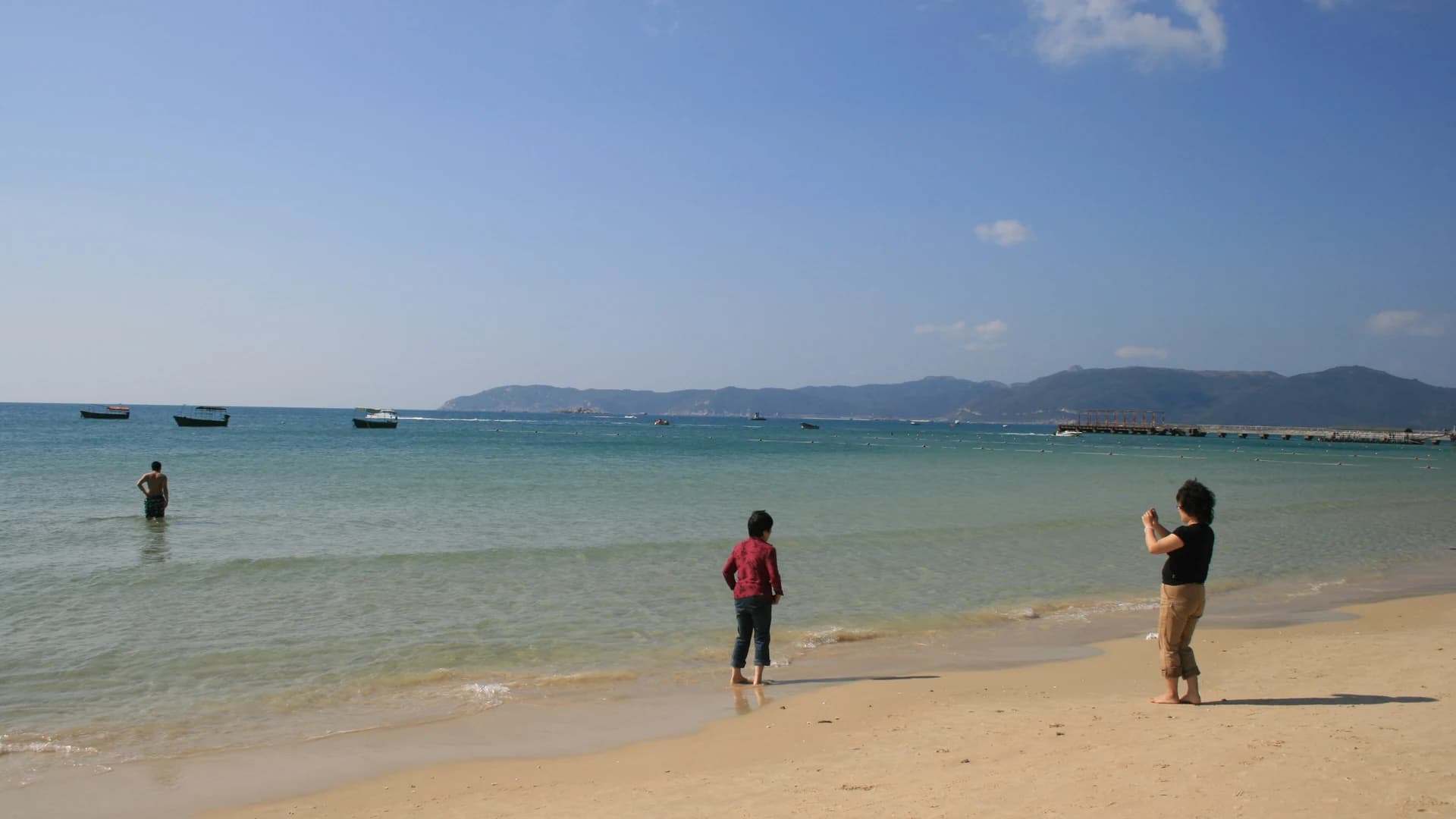 Yalong Bay's calm water and boats off the coast of Sanya, Hainan Island