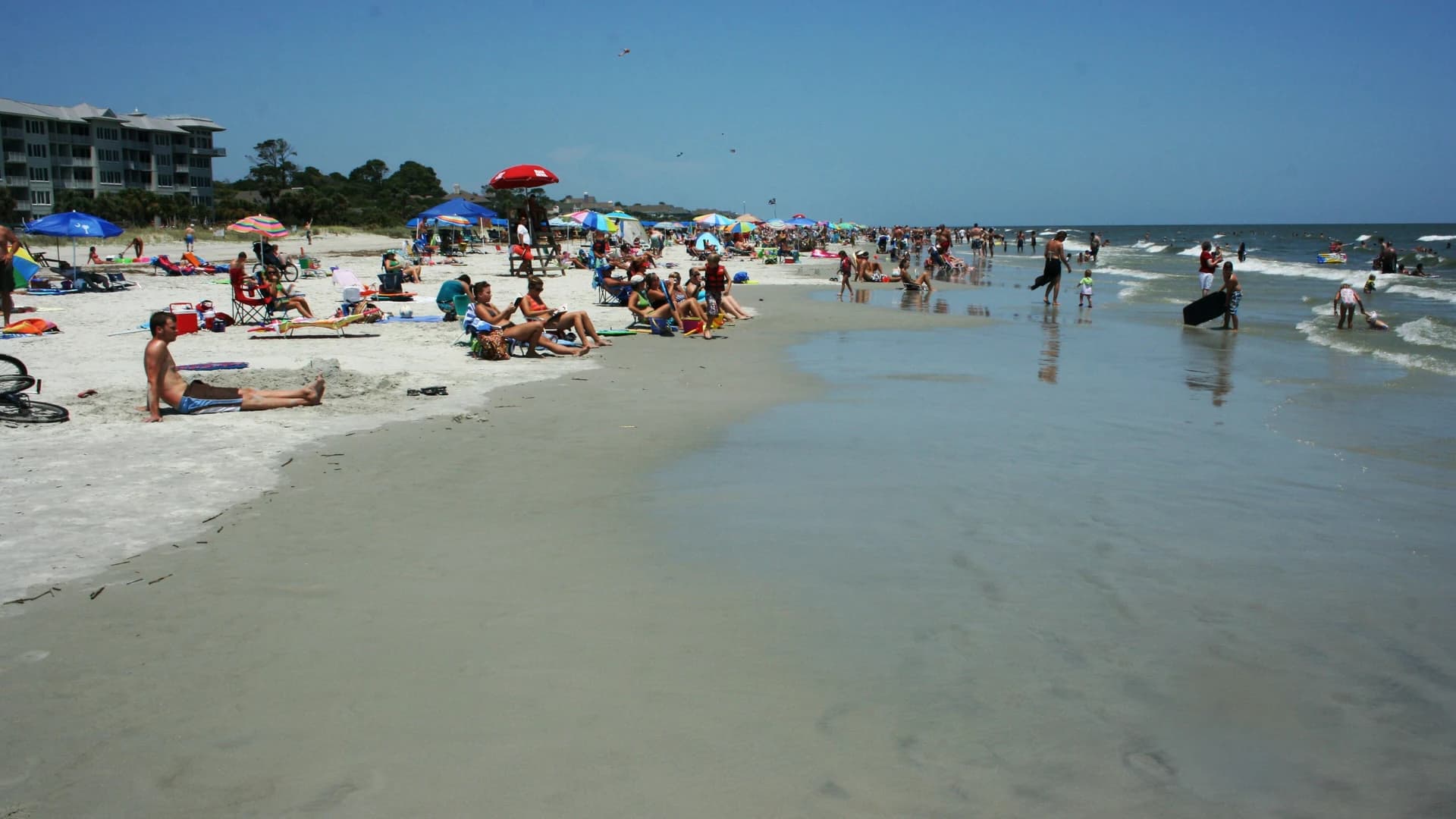 Beachgoers on the sand at Hilton Head Island, South Carolina, on a sunny summer day