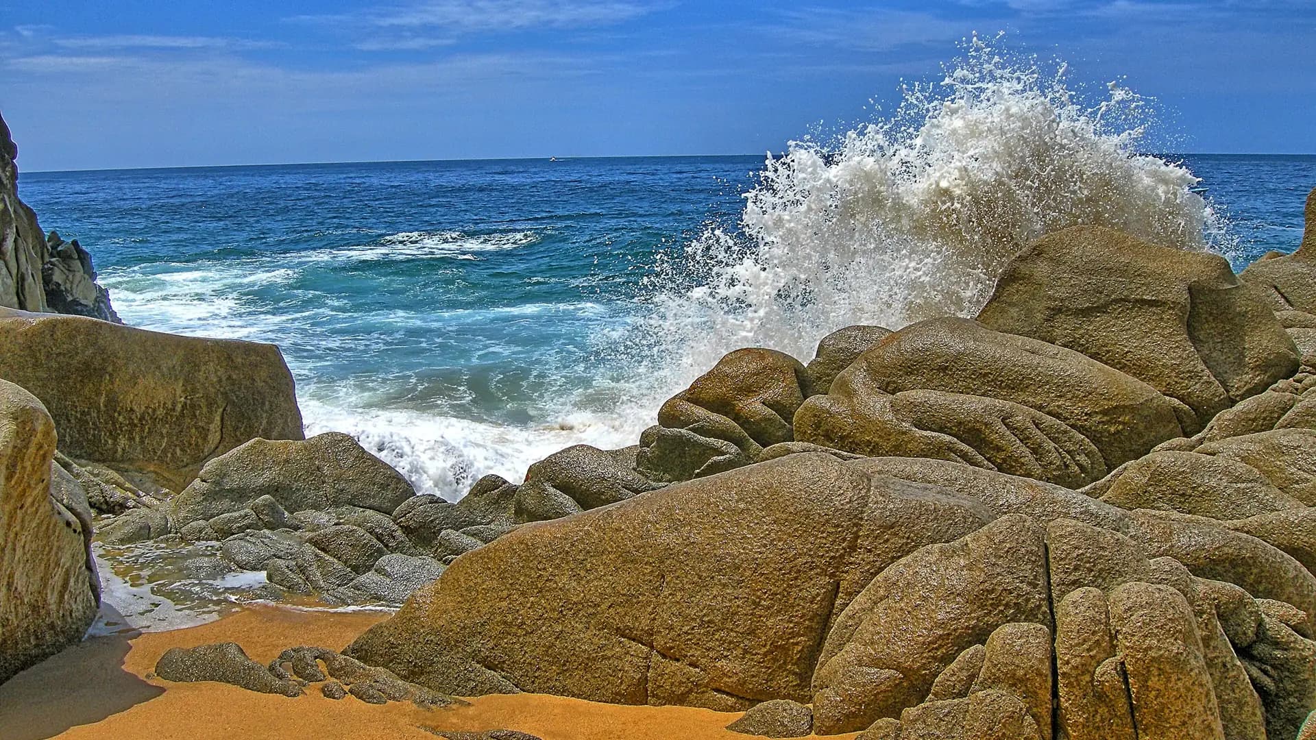 Rocky granite boulders and crashing waves at Lover's Beach near Land's End, Los Cabos, Mexico