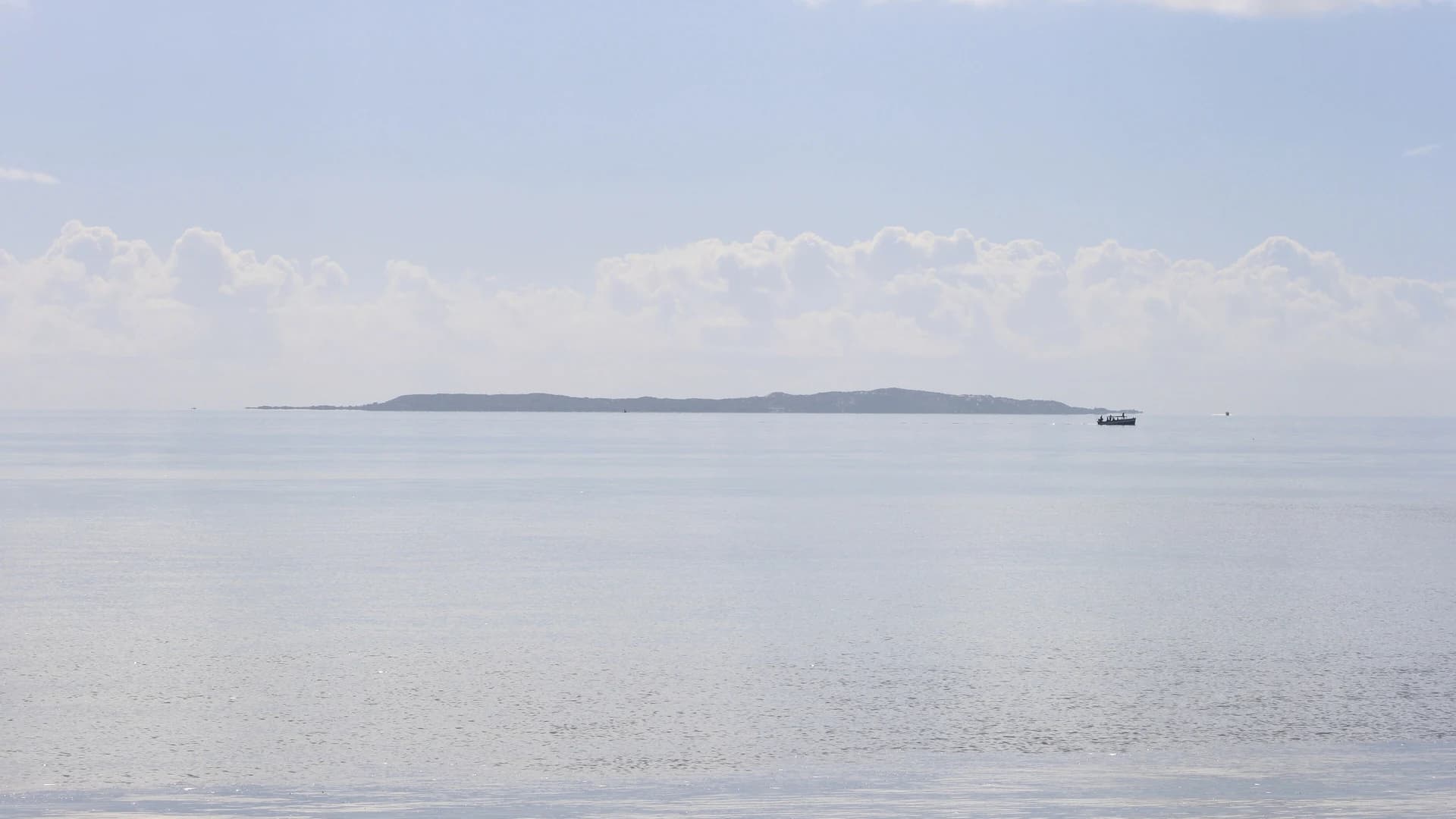 A dhow boat off an island in the Bazaruto Archipelago, seen from the Mozambique coast near Vilanculos