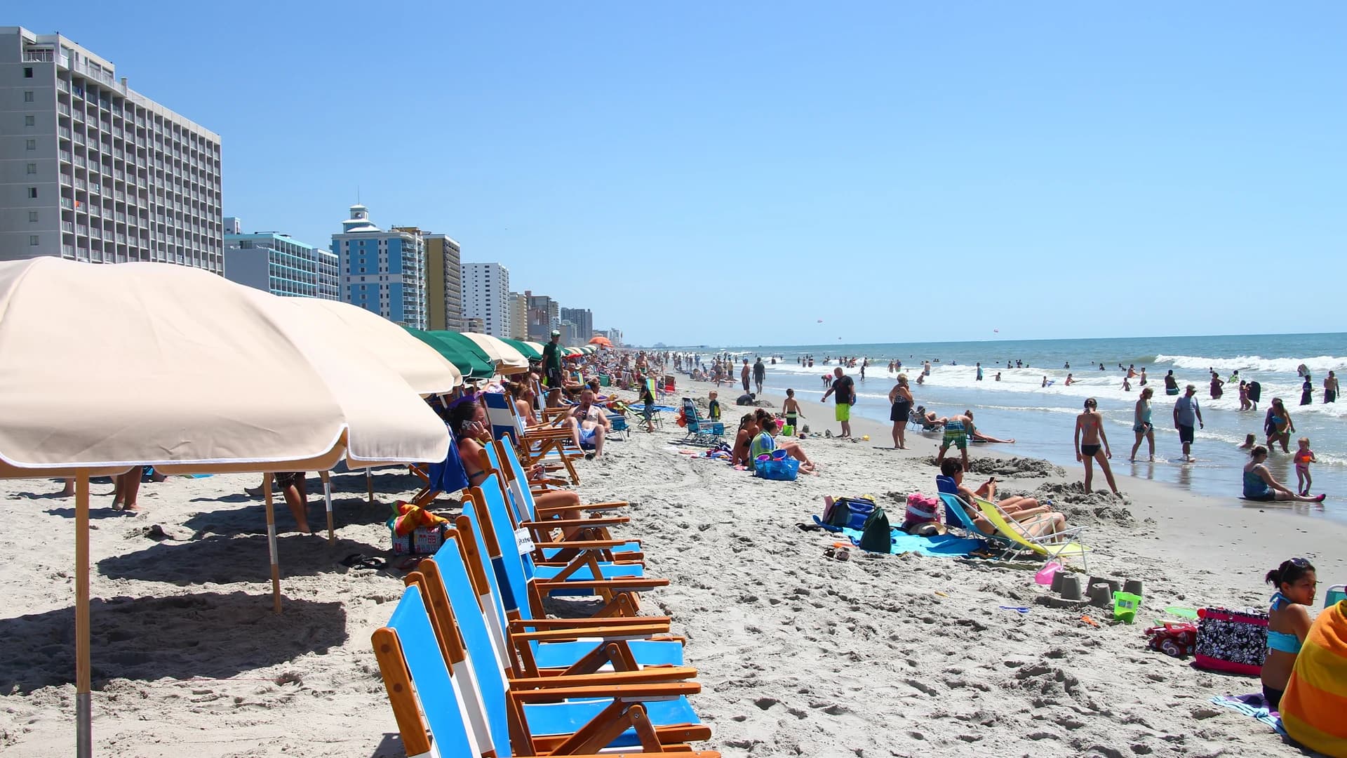 Oceanfront hotel towers and beach chairs lining the sand at Myrtle Beach, South Carolina