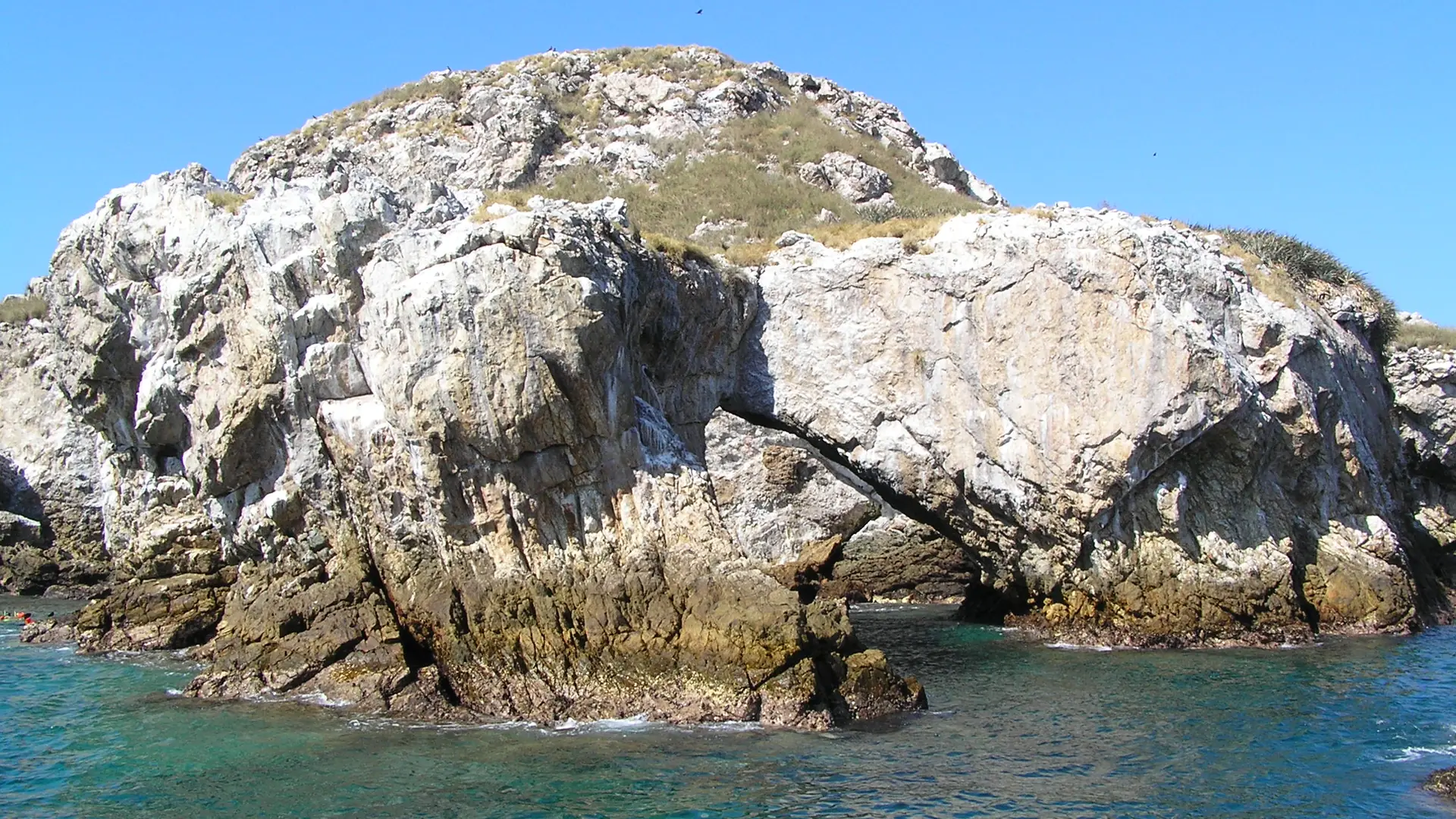 Rock arch formation in the turquoise waters of the Marietas Islands, near Punta Mita, Mexico