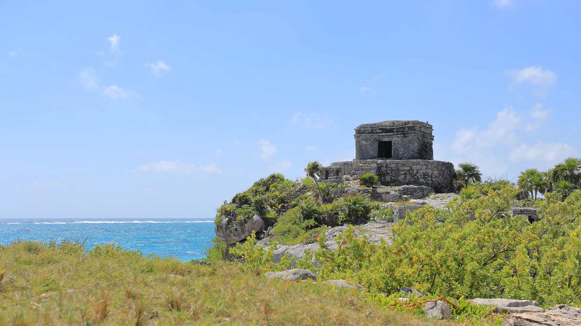 Tulum archaeological ruins on cliff above turquoise Caribbean waters, Mexico